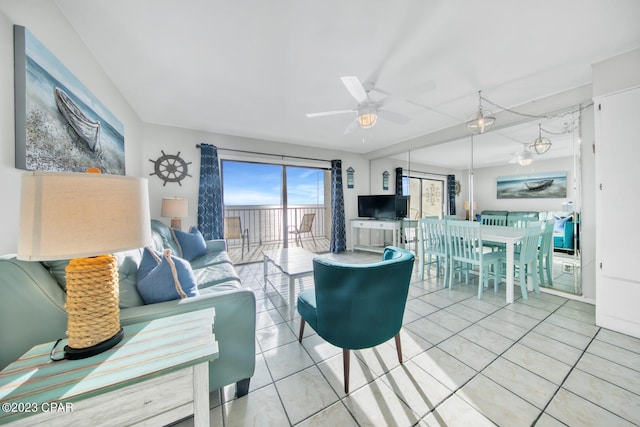 living room featuring ceiling fan and tile patterned floors