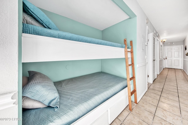 bedroom with light tile patterned floors