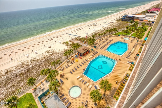 drone / aerial view with a water view and a view of the beach