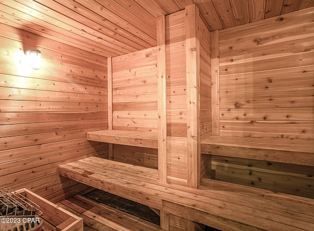 view of sauna featuring wooden walls and wooden ceiling