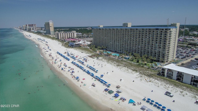 bird's eye view with a water view and a beach view