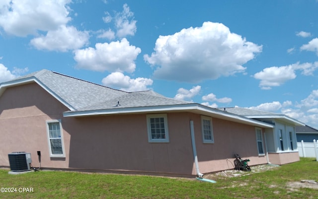 exterior space with a yard and central AC unit