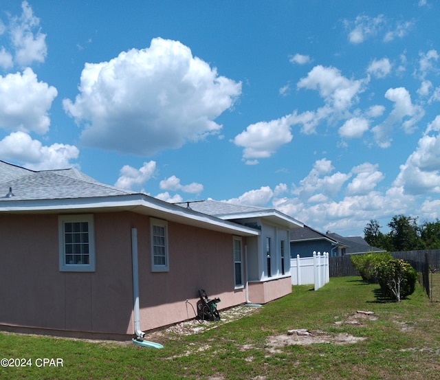 view of side of home featuring a yard