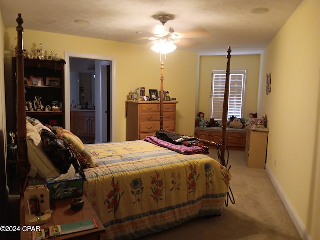 carpeted bedroom with connected bathroom and ceiling fan