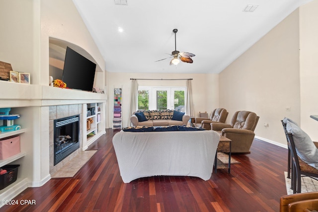 living room featuring ceiling fan, a fireplace, dark wood-type flooring, and vaulted ceiling