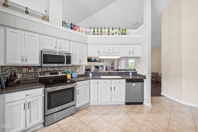 kitchen featuring white cabinetry, sink, high vaulted ceiling, light tile patterned floors, and appliances with stainless steel finishes