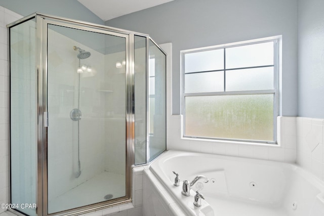 bathroom featuring independent shower and bath