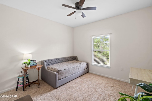 living area with light carpet and ceiling fan