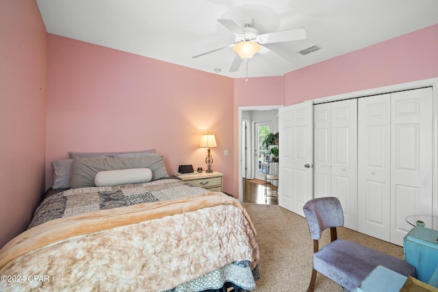 carpeted bedroom featuring ceiling fan and a closet