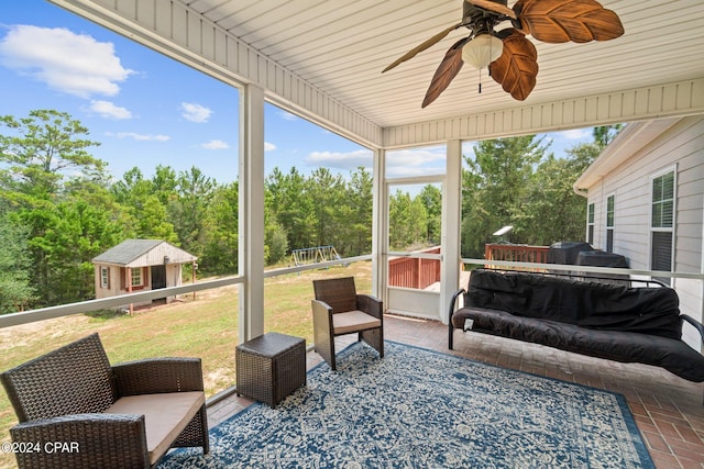 sunroom / solarium with ceiling fan and wooden ceiling