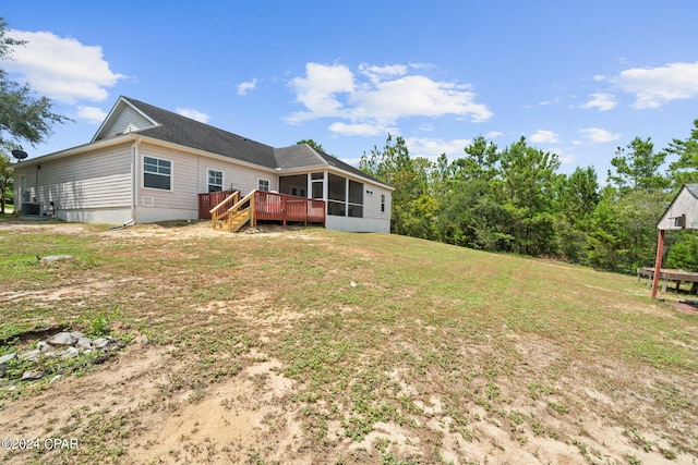 back of house with a yard, a deck, and a sunroom