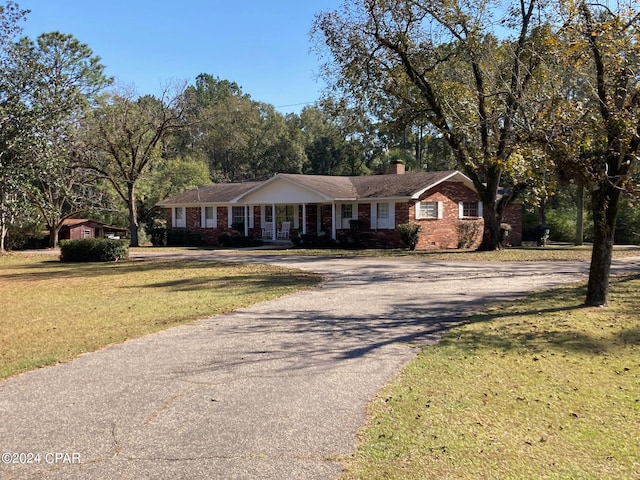 ranch-style home featuring a front yard