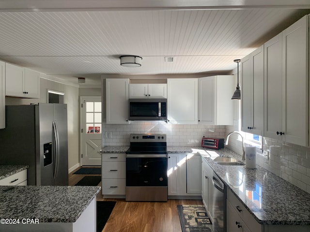 kitchen featuring stainless steel appliances, sink, backsplash, and dark hardwood / wood-style flooring