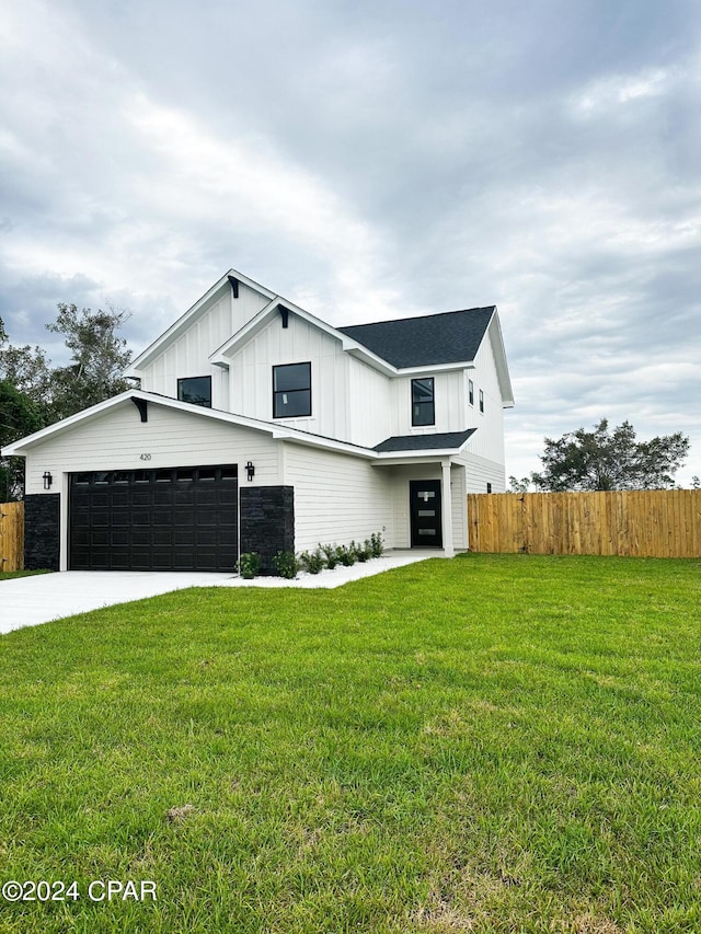 modern farmhouse style home with a front lawn