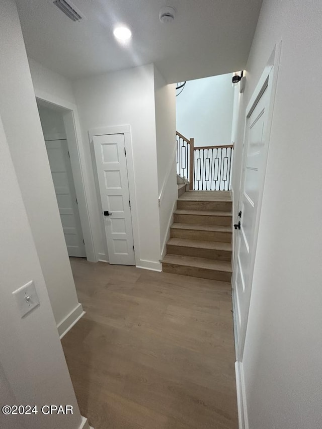 staircase featuring hardwood / wood-style floors