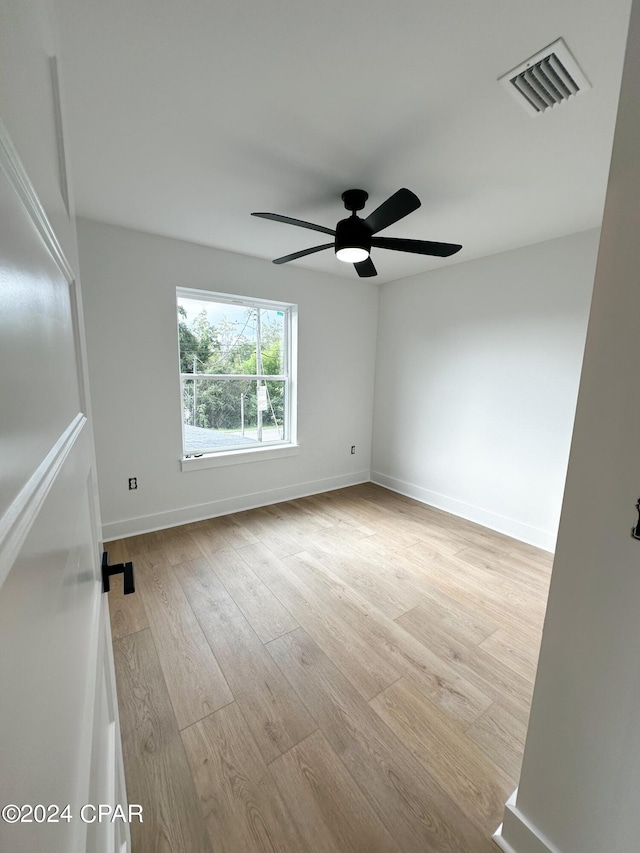 spare room with light hardwood / wood-style flooring and ceiling fan