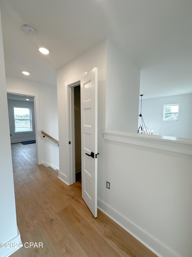 corridor with light hardwood / wood-style flooring