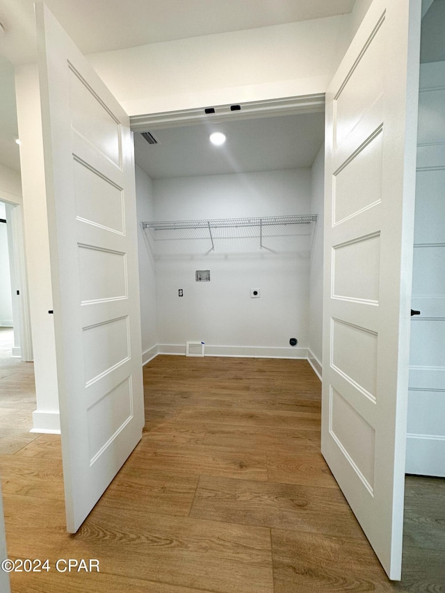 washroom featuring wood-type flooring, electric dryer hookup, and hookup for a washing machine