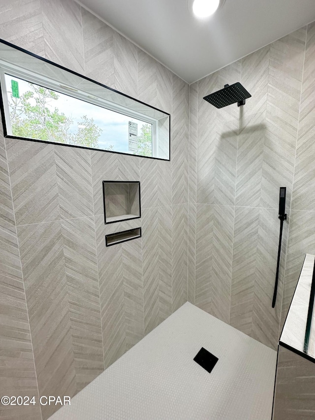 bathroom with a tile shower