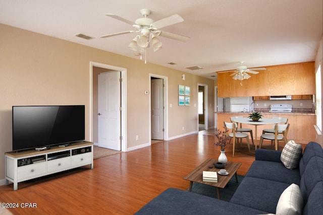 living room with ceiling fan and hardwood / wood-style flooring