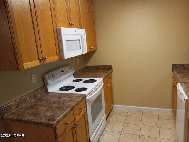 kitchen featuring white appliances and light tile patterned flooring