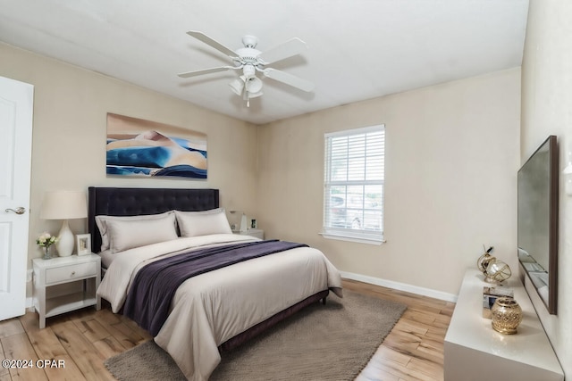 bedroom with light wood-type flooring and ceiling fan