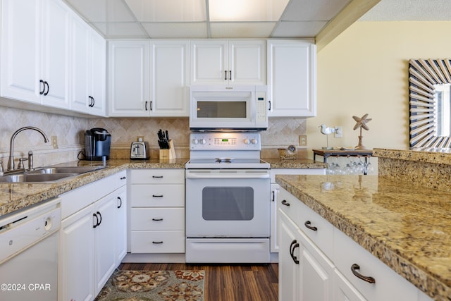 kitchen featuring white appliances, dark wood-style floors, white cabinets, and a sink