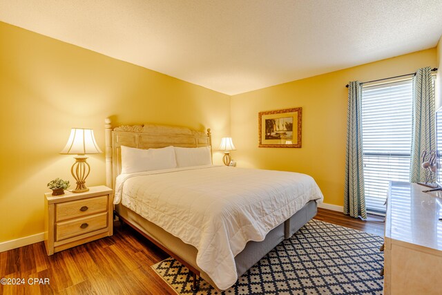 bedroom with wood finished floors and baseboards