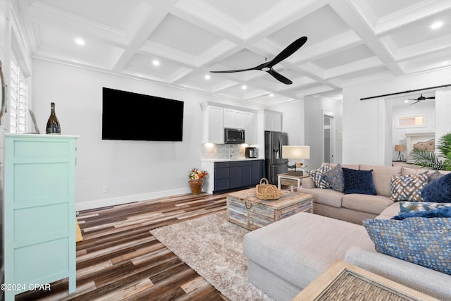 living room featuring ceiling fan, dark hardwood / wood-style floors, beam ceiling, and crown molding