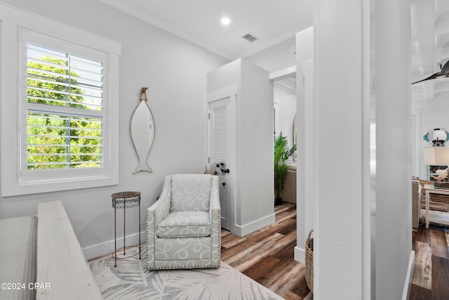 sitting room featuring crown molding and hardwood / wood-style flooring