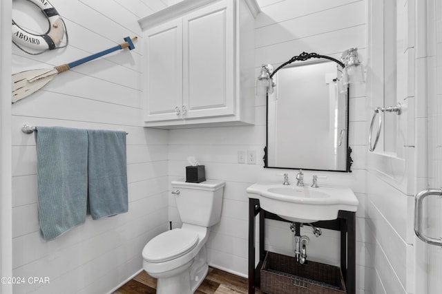 bathroom featuring toilet, hardwood / wood-style floors, and an enclosed shower