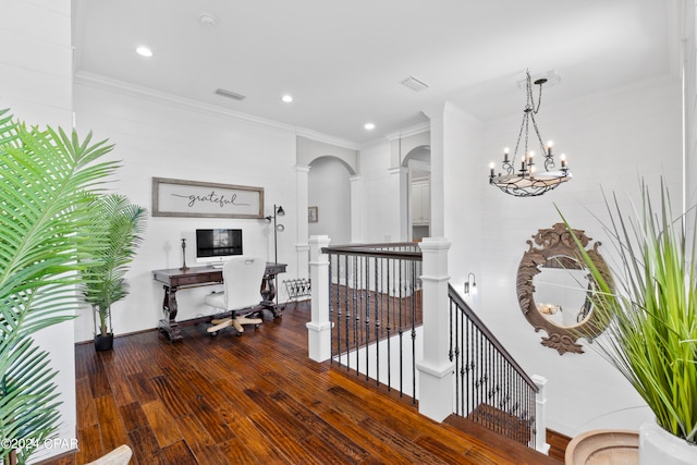 hall featuring a notable chandelier, dark hardwood / wood-style floors, and crown molding