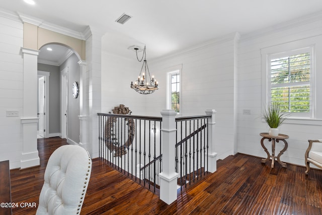 hallway with a chandelier, dark hardwood / wood-style floors, and crown molding