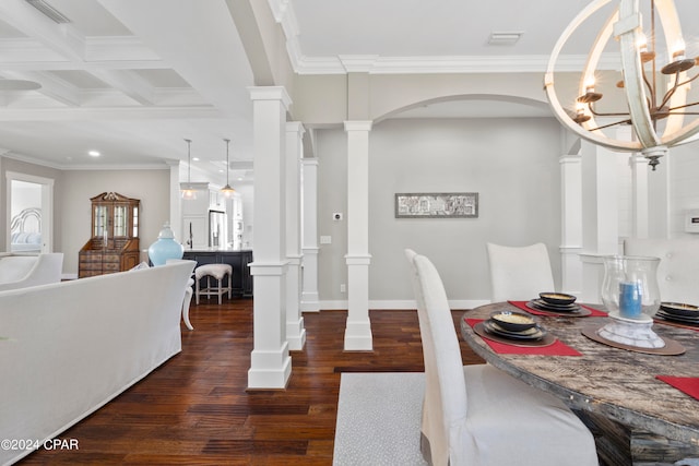 dining space featuring beamed ceiling, dark hardwood / wood-style floors, coffered ceiling, an inviting chandelier, and ornate columns