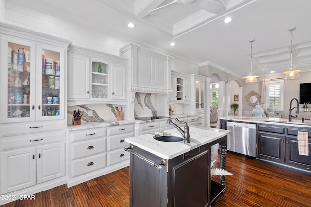 kitchen with white cabinets, dishwasher, a center island with sink, and sink