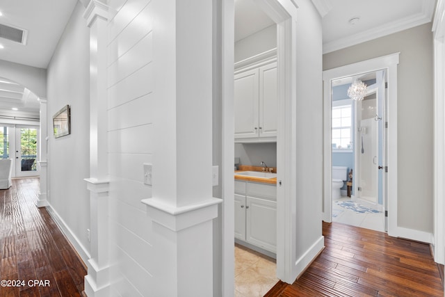 corridor featuring french doors, hardwood / wood-style flooring, sink, and a wealth of natural light