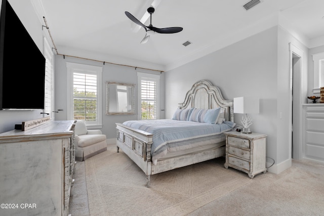 carpeted bedroom with ceiling fan and crown molding