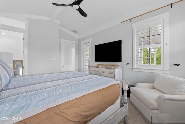 bedroom featuring ceiling fan, crown molding, lofted ceiling with beams, and carpet