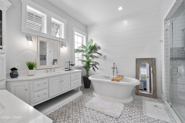 bathroom featuring shower with separate bathtub, vanity, and a wealth of natural light