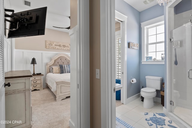 bathroom with tile patterned flooring, vanity, toilet, and an enclosed shower