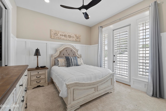 carpeted bedroom featuring ceiling fan, access to exterior, and multiple windows