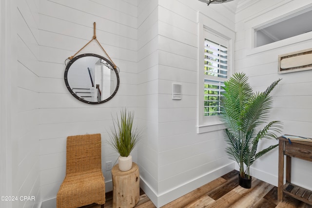 interior space featuring wood walls and hardwood / wood-style flooring