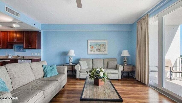 living room featuring dark hardwood / wood-style floors, sink, and ceiling fan