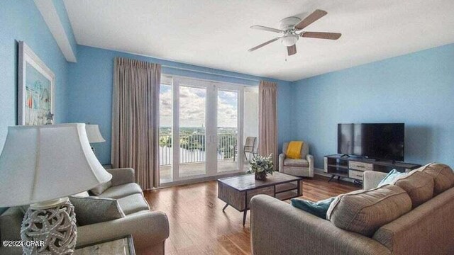 living room featuring ceiling fan and wood-type flooring