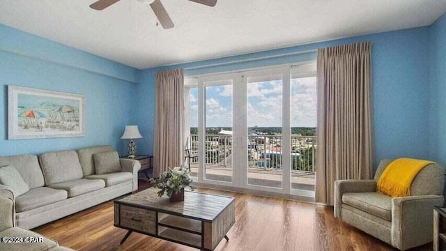 living room featuring hardwood / wood-style floors and ceiling fan