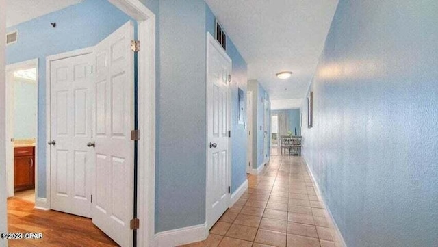 corridor featuring light tile patterned floors