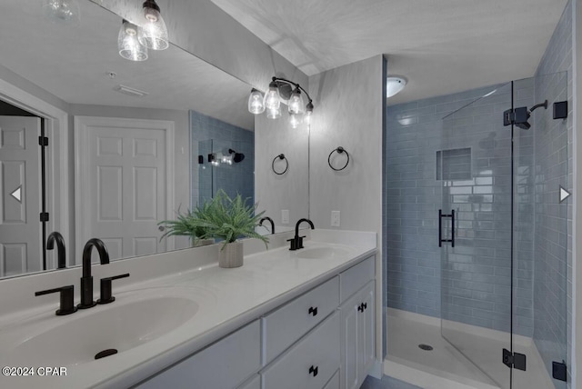 bathroom featuring vanity and a shower with shower door