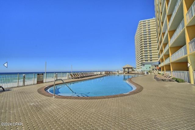 view of pool with a water view