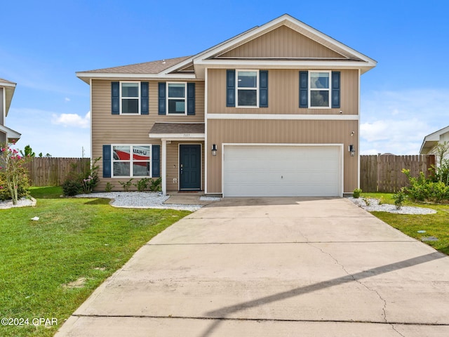 view of front facade with a garage and a front lawn