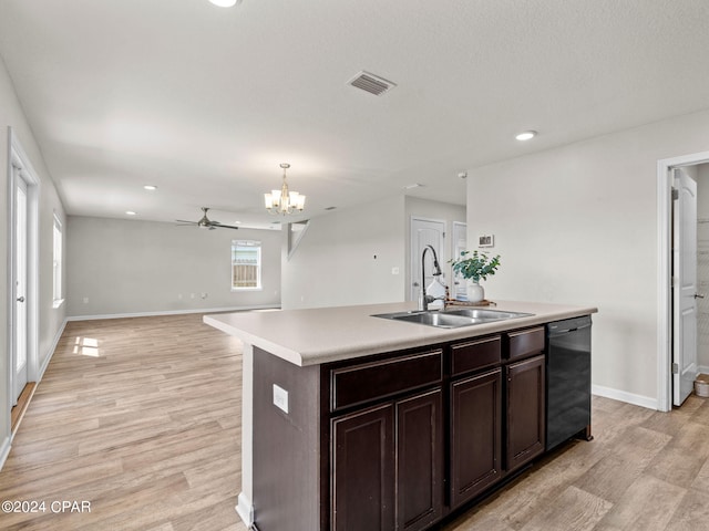 kitchen with dishwasher, light hardwood / wood-style flooring, sink, pendant lighting, and a kitchen island with sink